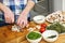 Man Chopping Mushrooms With Vegetables On Counter