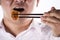 Man with chopsticks eat egg springroll