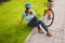 Man and city rolling bicycle, environmentally friendly transport. Beautiful young caucasian woman worker sitting resting on the gr