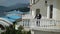 Man in classic black suit staying at the balcony near sea. Businessman or groom