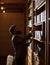 Man in classic suit stand in vintage interior, library,