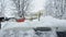 Man clean his car with brush from the snow. Person brushing fresh snow from car in the winter..