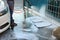 Man cleaning auto mats with high pressure foam jet at self-service car wash, closeup