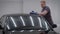 Man is cleaning automobile by cloth in a car washing room, rubbing roof, taking out dirt from surface