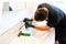 Man cleaning a bathroom sink with a scraper blade and micro fiber cloth to remove lime and stains