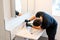 Man cleaning a bathroom sink with a scraper blade and micro fiber cloth to remove lime and stains