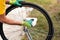 Man cleaning bicycle tire for new season