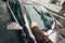 Man cleaning car windshields wipers before driving