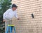 Man cleaning cedar shingles