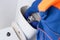 A man from a cleaning company collects the toilet bowl drain tank, after cleaning it, close-up