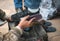 man cleaning customer shoes on city pavement.