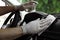 Man cleaning dashboard with wet wipe and antibacterial spray in car. Coronavirus pandemic