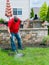 Man cleaning dirty grill plates from a barbecue