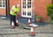 Man cleaning domestic sewage drain outside house in UK
