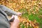 Man cleaning fallen autumn leaves in the yard