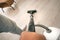 Man cleaning floor with vacuum cleaner at home. Vacuuming. House keeping concept