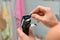 A man cleaning a hair clipper with a brush