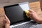 Man Cleaning Laptop Screen