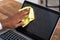 Man Cleaning Laptop Screen With Cloth