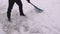 Man cleaning snow with a shovel. Selective focus.