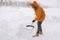 Man cleaning snow from sidewalk and using snow shovel. Winter season