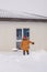 Man cleaning snow from sidewalk and using snow shovel. Winter season