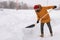 Man cleaning snow from sidewalk and using snow shovel. Winter season