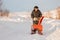 Man cleaning snow from sidewalks with snowblower machine winter