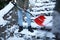 Man cleaning stairs from snow with shovel on winter day, closeup