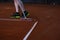 Man cleaning tennis court lines