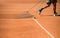 Man cleaning tennis terrain