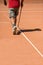 Man cleaning tennis terrain