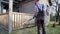 Man cleaning terrace with a power washer - high water pressure cleaner on wooden terrace railing