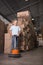 Man cleaning warehouse floor with machine