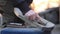 Man cleans the board with a metal brush