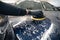 Man cleans car hood with circle sponge. Preparing auto for polishing. .Detailed car wash