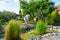 man cleans garden pond bottom with high-pressure washer from mud and sludge.