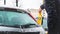 Man cleans his car from the snow