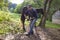 Man cleans horse hooves on farm