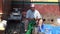 Man cleans icon lamp on the street in Kathmandu Nepal.