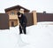 Man cleans snow around the house