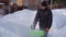 A man cleans snow in the winter in the courtyard of the house. man cleaning snow with a snow blower