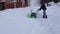 A man cleans snow in the winter in the courtyard of the house, man cleaning snow with a snow blower