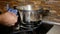 Man cleans the stove after milk boiling over a pan