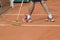 Man cleans tennis line on clay court