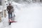 Man clearing driveway with snowblower