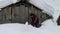 Man Clears The Door To An Abandoned Hut In The Highlands For An Overnight Stay