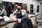 Man client taking selfie with haidresser in barber shop, coronavirus and new normal concept.