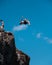 Man cliff diving and flipping at Waimea Bay on Oahu, Hawaii