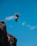 Man cliff diving and flipping at Waimea Bay on Oahu, Hawaii